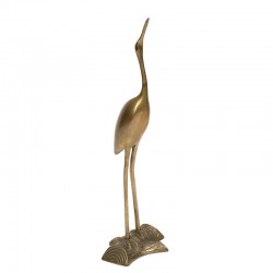 Vintage decorative crane on tree trunk in brass